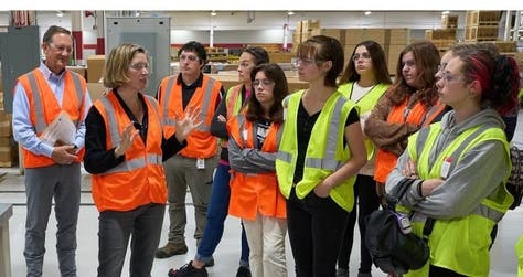 Cummins President and CEO Jennifer Rumsey joins high school students in touring one of the company’s engine plants as part of celebrations of International Day of the Girl