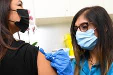 EDITORIAL USE ONLY Pharmacists, Meera Sharma administers a flu vaccination to Lisa Taylor from West London at Superdrug's Strand branch, as the retailer is the first to provide 2022-23 NHS and private flu vaccinations on a high street, London. Picture date: Wednesday September 7, 2022. PA Photo. Superdrug has seen an unprecedented increase in bookings compared to 2021 as patients look to mitigate the effects of increased socialising, international travel without COVID-19 restrictions and the impact of high flu rates in the Southern Hemisphere. Photo credit should read: Doug Peters/PA Wire