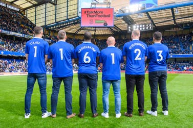 Former Chelsea players Gary Cahill, Jimmy Floyd Hasselbaink and Eiður Guðjohnsen (named shirts) and Chelsea fans (l-r) Marcus Cuthbert, Carlo Capelli, and Fabio Agostini show the Samaritans’ 24-hour helpline number 116 123 printed on the back of their shirts during the launch of the TalkMoreThanFootball campaign from Three, sponsors of Samaritans, during halftime of Chelsea vs Brighton at Stamford Bridge. Picture date: Saturday 15 April, 2023. PA Photo. The campaign aims to encourage fans to open up after new research reveals that British people are twice as likely to talk about football than their mental wellbeing. Picture credit should read: Matt Crossick/PA Wire.