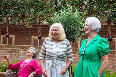 Anne in green, at Gradwell Park, laughing with friends