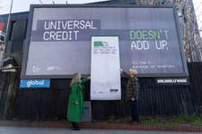 EDITORIAL USE ONLY (L-R) Russell Trust CEO Emma Revie and Warrington Foodbank volunteer Ben Pennell pull a giant receipt from a billboard installation near Finsbury Park Tube station in London, commissioned by the Trussell Trust and the Joseph Rowntree Foundation as part of their ‘It Doesn’t Add Up Campaign’, aiming to highlight issues following the launch of the new Universal Credit amount. Picture date: Tuesday April 4, 2023. PA Photo. The different parts of the receipt, which include personal cost of living crisis stories, actual costs of essentials, and messages of anger, will be torn off and pasted up on display in the area around the billboard.