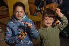 EDITORIAL USE ONLY Rosie Bowden, age 9, and Micah Tenque, age 5, create bee pompoms at The Box in Plymouth as part of The Wild Escape, a project led by Art Fund aiming to highlight the UK’s biodiversity crisis ahead of Earth Day on Saturday April 22. Picture date: Wednesday April 19, 2023. PA Photo. The project, supported by Arts Council England and inspired by BBC One’s Wild Isles series, is the largest ever collaboration between the UK’s museums inspiring thousands of children to visit local museums and respond creatively to the threat to the UK’s natural environment by looking for animals featured in museum collections and creating their own wildlife artworks.