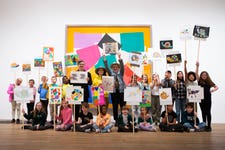 EDITORIAL USE ONLY Children and artists (middle, l-r) Mark Wallinger, Es Devlin and Bob and Roberta Smith (correct artists' name of the man in hat) parade their artwork inspired by ‘The Snail’ by Henri Matisse at Tate Modern as part of The Wild Escape, a project led by Art Fund aiming to highlight the UK’s biodiversity crisis ahead of Earth Day on Saturday April 22. Picture date: Wednesday April 19, 2023. PA Photo. The project, supported by Arts Council England and inspired by BBC One’s Wild Isles series, is the largest ever collaboration between the UK’s museums inspiring thousands of children to visit local museums and respond creatively to the threat to the UK’s natural environment by looking for animals featured in museum collections and creating their own wildlife artworks.