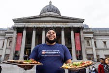 EDITORIAL USE ONLYBig Zuu in Trafalgar Square, London giving out slices of ‘Big Zuu's Zillionaire Rustica’, a pizza he has designed exclusively for Zizzi to mark the launch of their Zillionaires’ Club loyalty platform. Picture date: Thursday November 2, 2022. PA Photo. Customers who sign up to the platform will rewarded with a free garlic bread, free food each time they visit, be able to use click and collect services, and purchase Zizzi for delivery. Big Zuu’s Zillionaire Rustica is now live on the menu nationwide.