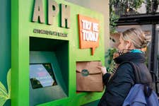 EDITORIAL USE ONLY Members of the public interact with Meatless Farm's Automated Plant Machine (APM) at BOXPARK in Shoreditch. Picture date: Thursday January 19, 2023. PA Photo. Meatless Farm is launching the UKÕs first APM to encourage people to eat more plants as new research reveals only 1 in 10 UK adults eat their five-a-day. The 'planty' twist on an ATM, dispenses free veg and plant-based food