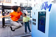 DITORIAL USE ONLY Amara Campbell interacts with the ‘Joy ATM’, as it is unveiled on Oxford Street in London by Samsung, where people can win prizes including cash in exchange for acts of joy, such as telling a joke or sharing a smile. Picture date: Thursday June 8, 2023. PA Photo. The ATM marks the launch of Samsung's cashback summer promotion and follows research that shows over half of the UK value small bursts of joy over bigger, life changing moments.