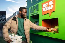 EDITORIAL USE ONLY Members of the public interact with Meatless Farm's Automated Plant Machine (APM) at BOXPARK in Shoreditch. Picture date: Thursday January 19, 2023. PA Photo. Meatless Farm is launching the UKÕs first APM to encourage people to eat more plants as new research reveals only 1 in 10 UK adults eat their five-a-day. The 'planty' twist on an ATM, dispenses free veg and plant-based food.