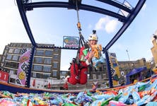 Tash Randolph demonstrates the ‘PROPER Dropper’, the UK’s first human claw arcade machine, ahead of its launch on October 28, giving people the chance to win free snacks and thousands of pounds worth of prizes. Issue date: Thursday October 27, 2022. PA Photo. Opening in Ely’s Yard, Shoreditch for two days only, The arcade machine contains a pit of 16,000 bags of PROPER Snacks, as well hidden gold packs with prizes from brands such as NICCE, ByRotation, FILA, and SONOS.