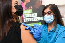 EDITORIAL USE ONLY Pharmacists, Meera Sharma administers a flu vaccination to Lisa Taylor from West London at Superdrug's Strand branch, as the retailer is the first to provide 2022-23 NHS and private flu vaccinations on a high street, London. Picture date: Wednesday September 7, 2022. PA Photo. Superdrug has seen an unprecedented increase in bookings compared to 2021 as patients look to mitigate the effects of increased socialising, international travel without COVID-19 restrictions and the impact of high flu rates in the Southern Hemisphere. Photo credit should read: Doug Peters/PA Wire