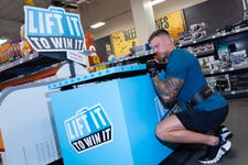 EDITORIAL USE ONLY Former Love Island contestant and fitness entrepreneur Alex Bowen attempts to lift the lid of the ‘worlds heaviest freezer door’, weighing 170kg, as part of the ‘Lift it, to win it’ competition from Myprotein. Issue date: Monday May 15, 2023. PA Photo. The competition, which takes places from Friday May 19 to Sunday May 21 at the Iceland/Food Warehouse Tottenham store in North London, will see the first person to successfully lift the lid win the freezer’s entire contents, a year’s supply of Myprotein meals. Picture credit should read: Rachel Adams/PA Wire.