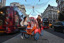 EDITORIAL USE ONLY Grace Chau on the Merchant Gourmet ‘Chestnut Chariot’, a rickshaw offering free rides to Christmas shoppers around central London to mark the expansion of the brand’s chestnut snack range. Issue date: Thursday November 24, 2022. PA Photo. The launch of the service, which offers riders a chestnut blanket to keep warm, chestnut snacks and chestnut-themed Christmas tunes, follows research showing that over a quarter of British people have never tried the historic festive snack.