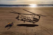 EDITORIAL USE ONLY Aerial views of a 75-metre piece of sand art depicting a military Chinook helicopter on Saunton Sands beach in Devon as part of the Defence Infrastructure Organisation (DIO) ëRespect the Rangeí campaign, warning holidaymakers and locals to check military firing and training times when accessing Ministry of Defence (MOD) sites this summer. Issue date: Thursday August 4, 2022. PA Photo. The safety initiative aims to warn visitors about the risks they face when entering shared land used by the MOD for training, including live firing, unexploded ordnance and fast-moving military vehicles. Sites that pose significant risk to locals and tourists include Lulworth, Holbeach, Donna Nook, Barry Buddon, Lydd & Hythe, Salisbury Plain and Aldershot.